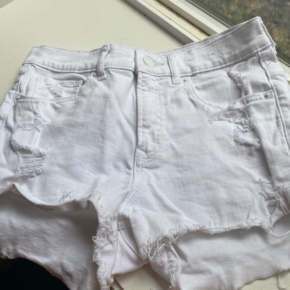 White ripped denim shorts, front is shorter than back